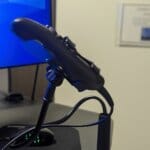 Side view of adjustable screw clamp base on a gooseneck arm used as a hands-free PowerScribe dictation microphone holder